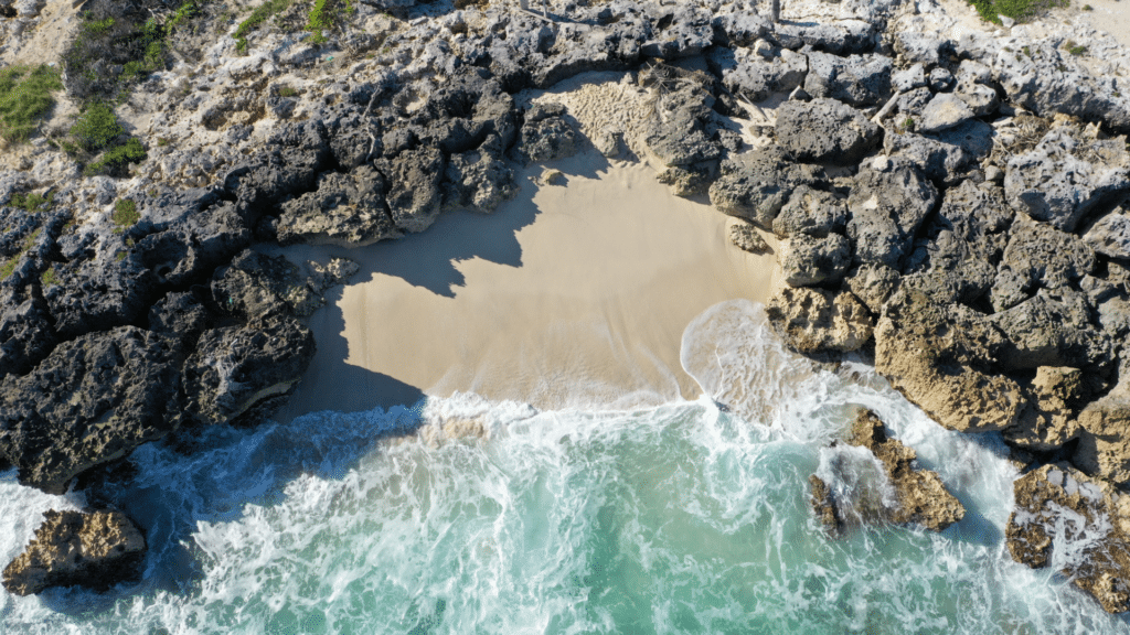 Aerial view of a secluded sandy cove along the Caribbean coast